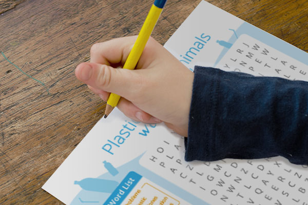 Child filling out word search